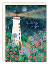 Greeting card with a lighthouse and flowers under a starry night sky, featuring the text 'Thinking of you'.