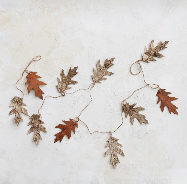 Decorative leaf garland on a textured white surface