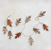 Decorative leaf garland on a textured white surface