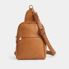 A brown vegan leather sling bag with a front zip pocket and adjustable strap, displayed against a plain background.
