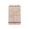 Notebook with mushroom illustration and 'Shitake Happens' text on a beige background