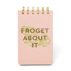 Pink notebook with gold text 'Froget About It' on a white background
