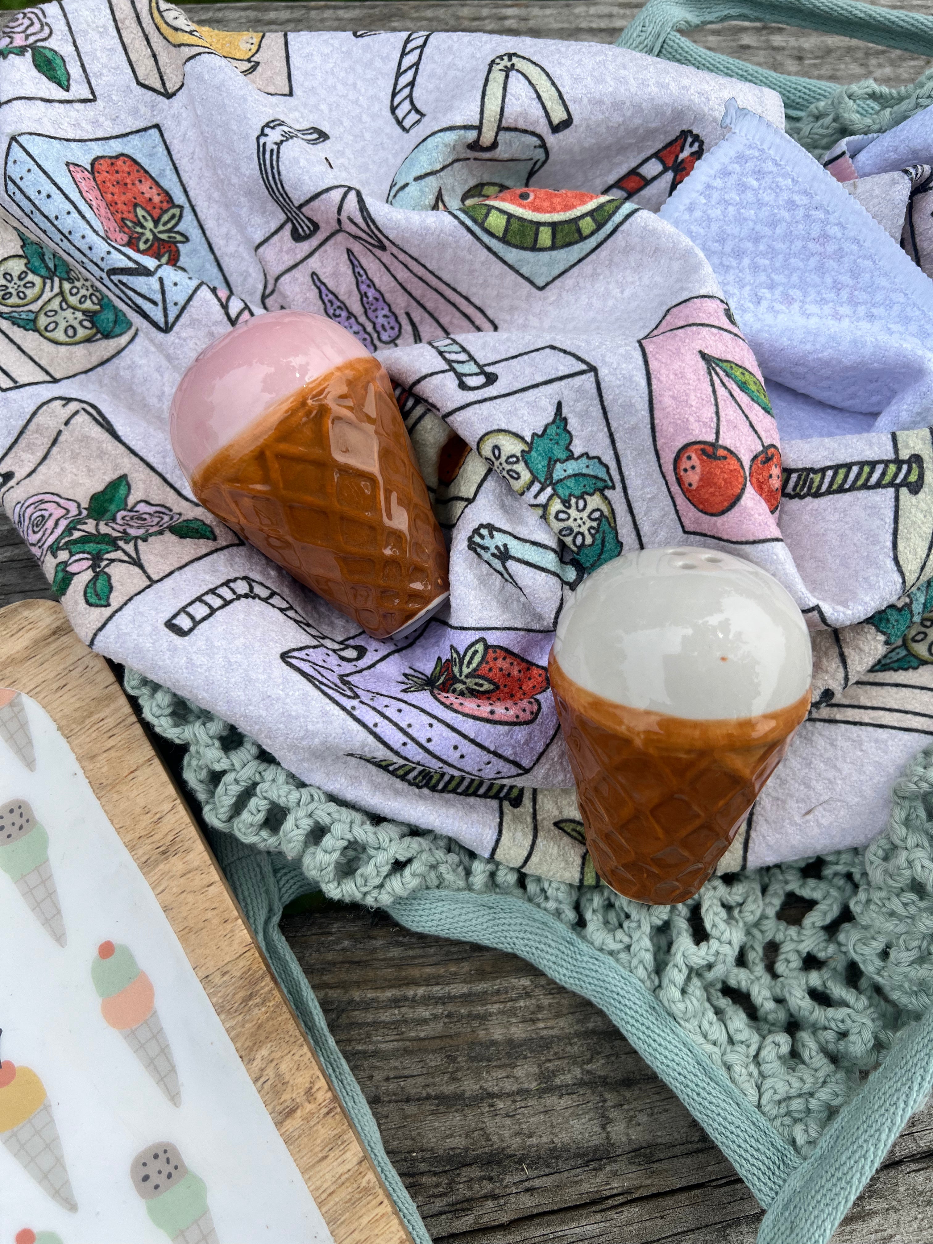 Decorative towel with ice cream-themed illustrations featuring a pink ice cream, brown cone, and white scoop.