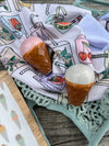 Decorative towel with ice cream-themed illustrations featuring a pink ice cream, brown cone, and white scoop.