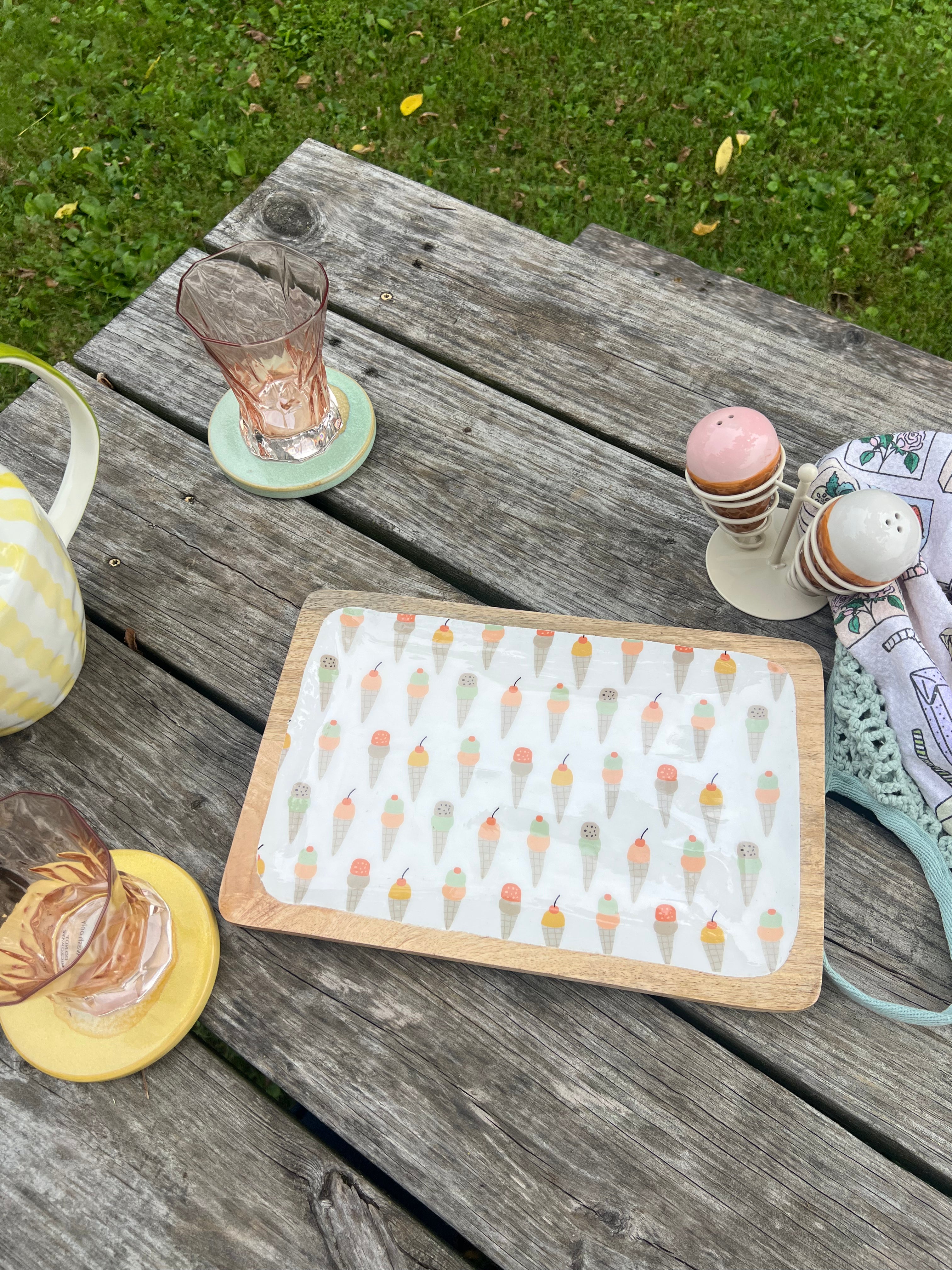 Wooden tray with ice cream pattern on a wooden table outdoors