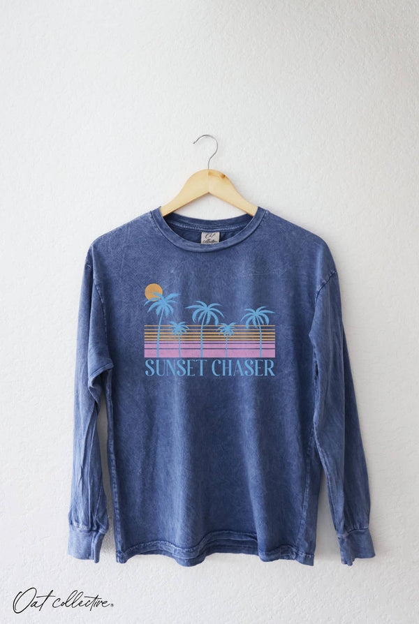 Blue long-sleeve shirt with 'Sunset Chaser' design on a hanger against a white background