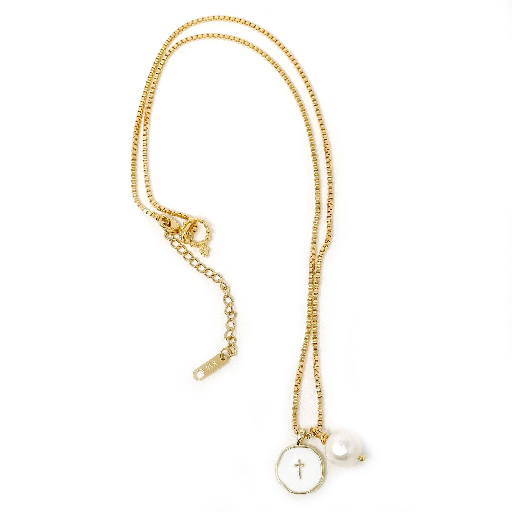 Gold necklace with a cross pendant on a white background