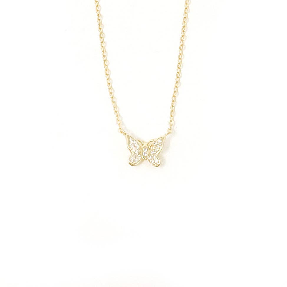 Gold butterfly necklace on a white background