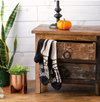 Pair of black and white socks hanging on a wooden drawer with decorative items.