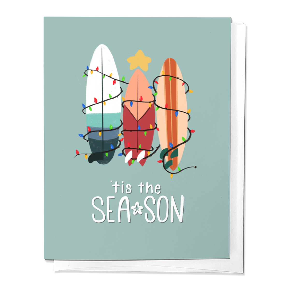 A greeting card with surfboards decorated in Christmas lights, titled 'TIS THE SEA-SON' on a blue background.