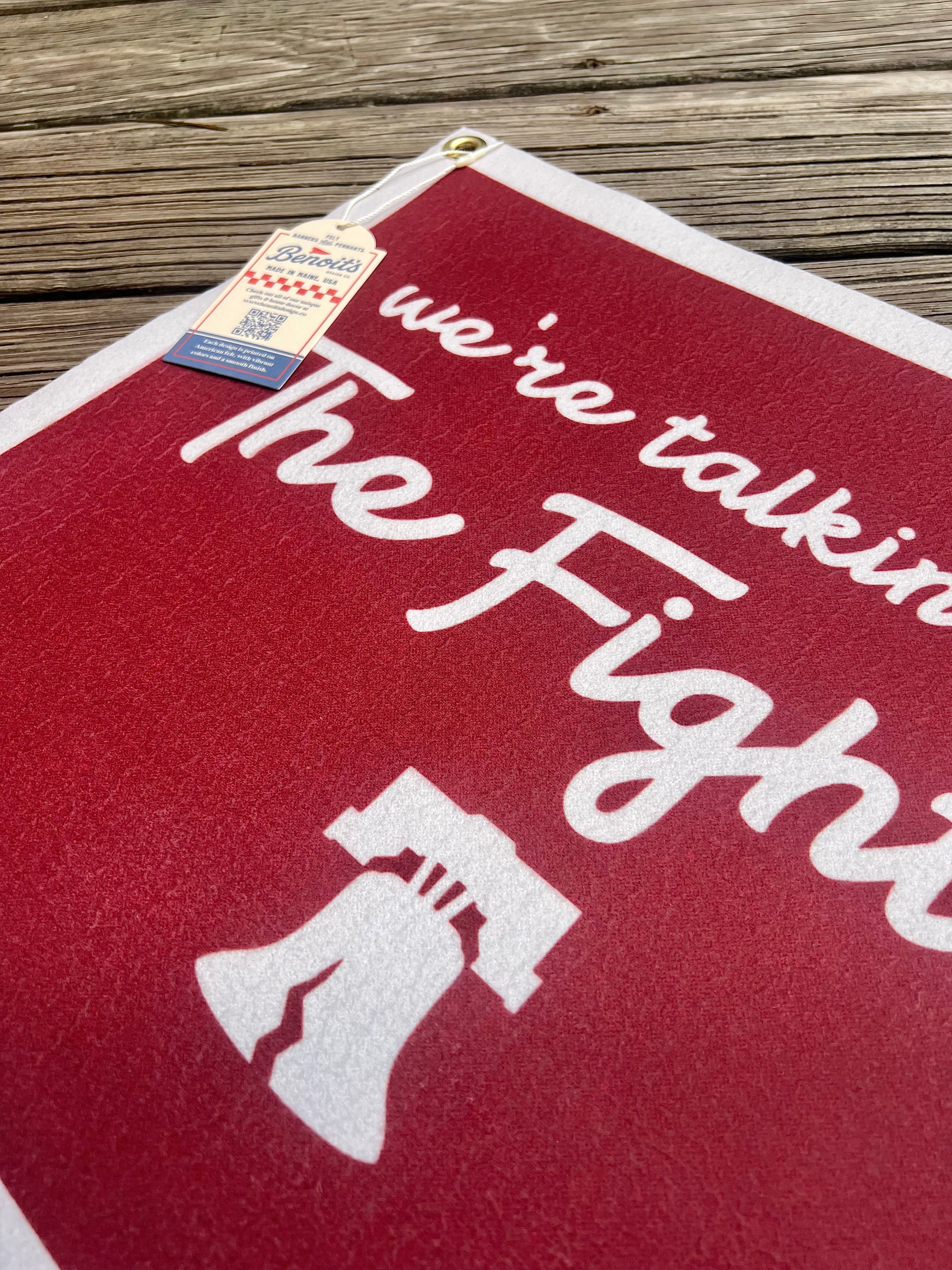 Red towel with white text and graphic on a wooden surface