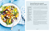 Plate of roasted butternut squash, beetroot & goat's cheese salad on a blue tablecloth with a recipe card next to it.