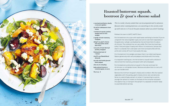 Plate of roasted butternut squash, beetroot & goat's cheese salad on a blue tablecloth with a recipe card next to it.