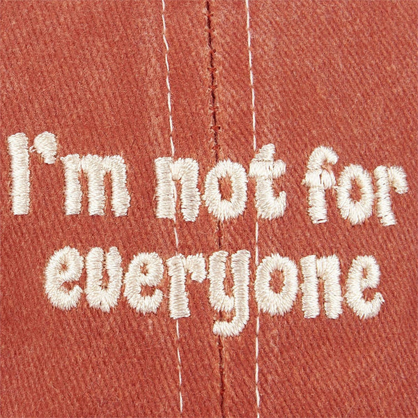 Red cap with white embroidered text 'I'm not for everyone' on a red background