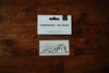 A set of temporary tattoos featuring a hand-drawn desert scene, packaged on a card.