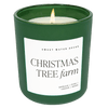 A green matte glass jar with a label that reads 'Christmas Tree Farm' and a brief description of the scents including pine, spruce, and cedarwood.