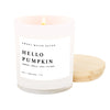 An 11 oz soy wax candle with a white label that reads 'HELLO PUMPKIN' in a white jar, with a wooden lid, on a white background.