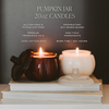 Two pumpkin jar candles on books with product details text overlay