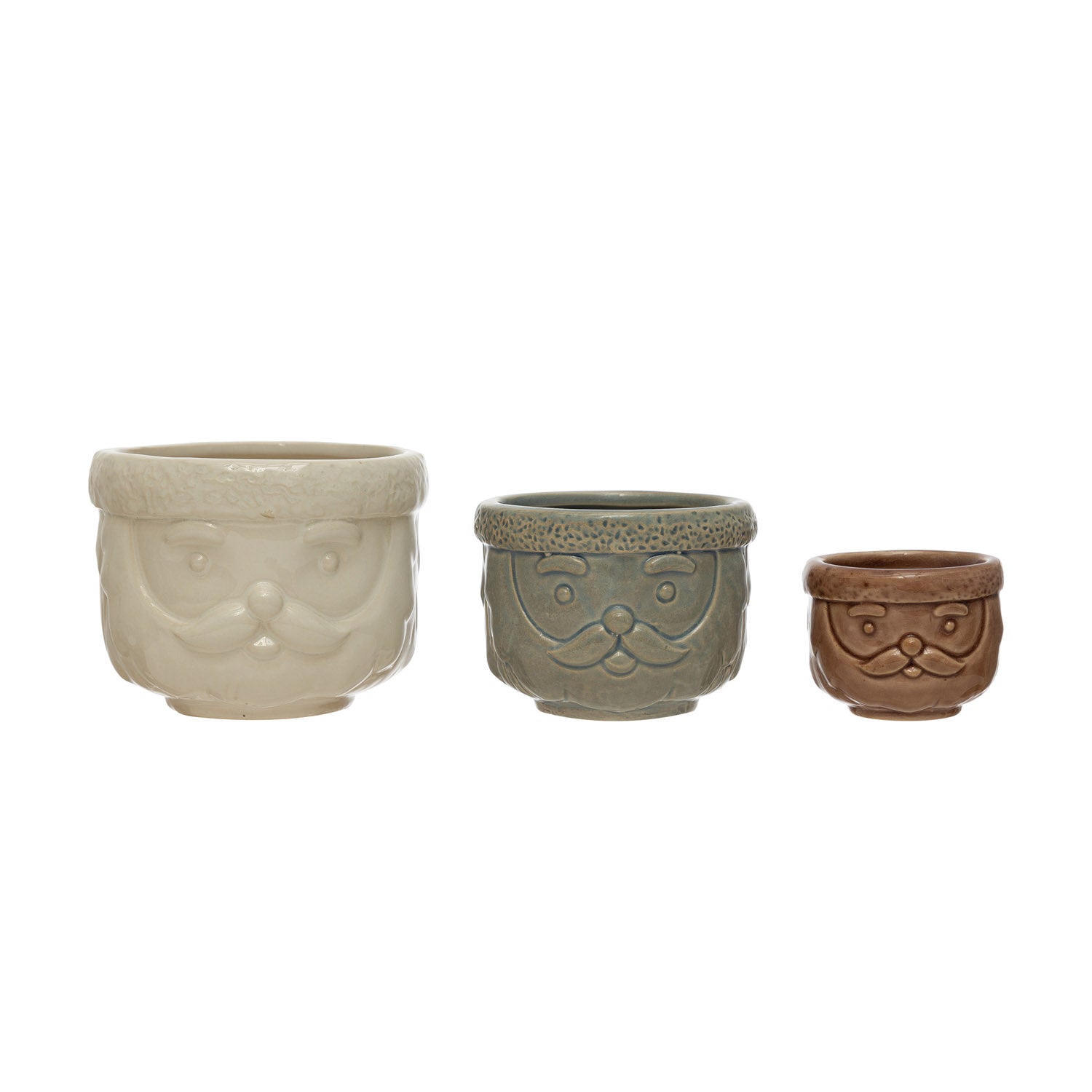 A set of three ceramic decorative containers with a Santa Claus design, in different sizes, with a beige, gray, and brown color scheme.