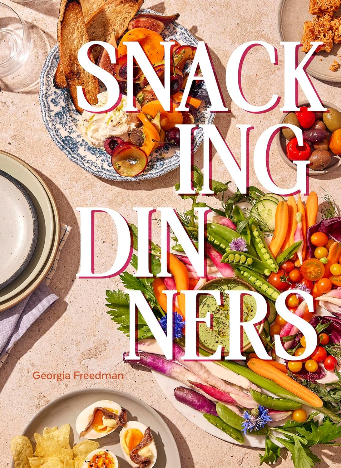 Book cover of 'Snacking Dinners' with plates of food and vegetables on a table.