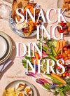 Book cover of 'Snacking Dinners' with plates of food and vegetables on a table.