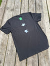 Black t-shirt with star designs on a wooden surface
