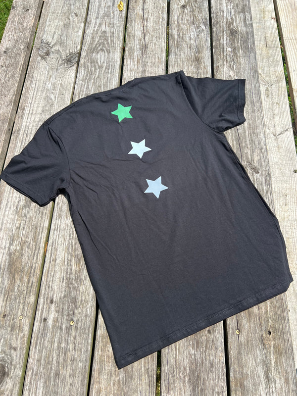Black t-shirt with star designs on a wooden surface
