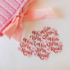 White shirt with red text and pink hearts on a white background