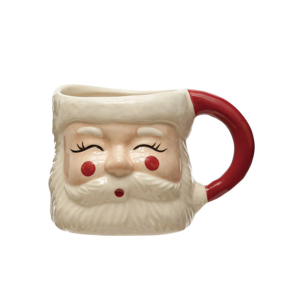 A hand-painted stoneware mug with a red and white Santa design, featuring a rounded body and a handle on the side.