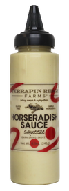 A bottle of Horseradish Aioli garnishing sauce with a black squeeze dispenser.