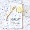 Towel with a cupcake graphic and text on a marble background with sprinkles