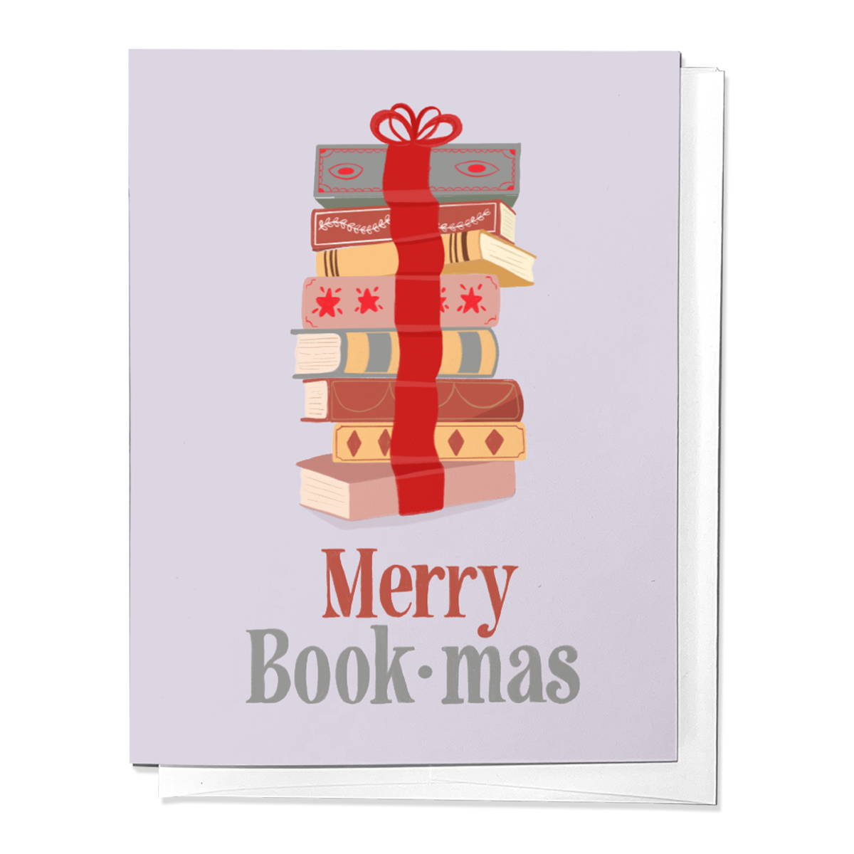 A greeting card with a stack of books wrapped with a red bow and the text 'Merry Book-mas' printed on the front. The card is displayed against a white background.