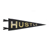 A black and gold pennant with the word 'HUSTLE' printed in gold lettering.