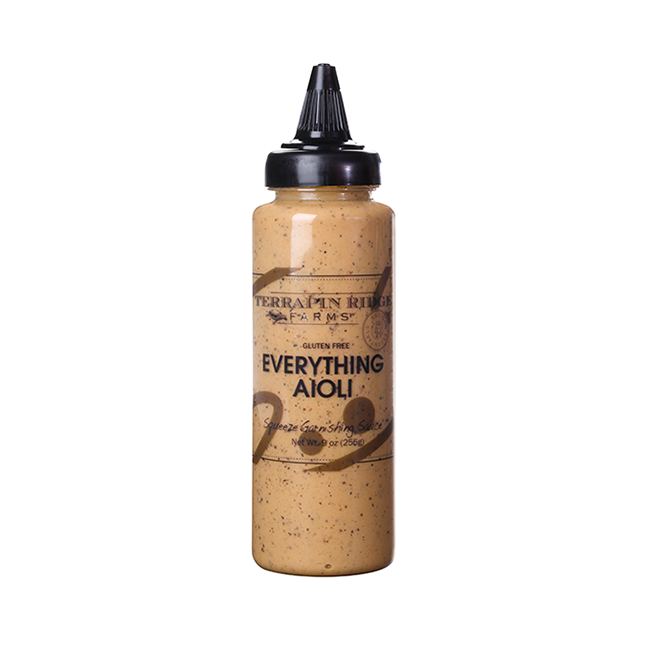 A squeeze bottle labeled 'Terrapin Ridge Everything Garnishing Aioli' with a brownish sauce visible inside the bottle.