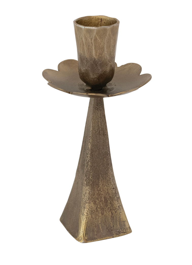 A rustic bronze metal candle holder with a textured, aged finish, featuring a tapered base and a petal-shaped cup, isolated on a white background.