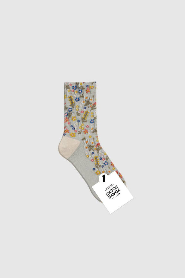 Floral-patterned sock with a gray heel and toe on a white background
