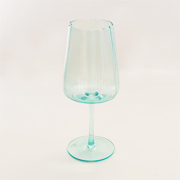 A single translucent light aqua glass goblet with a wide bowl, a slender stem, and a flat circular base, photographed against a plain off-white background.