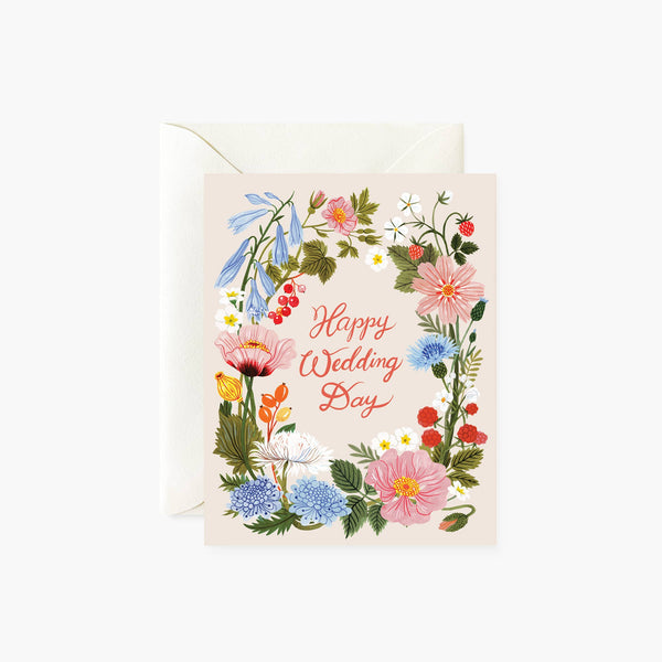A folded greeting card with a floral design and the text 'Happy Wedding Day' on the front, paired with an envelope.