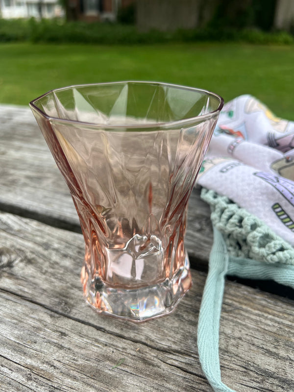 Clear glass on a wooden surface with a blurred outdoor background