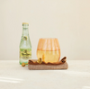 Bottle of Tupperware on a white surface with a neutral background