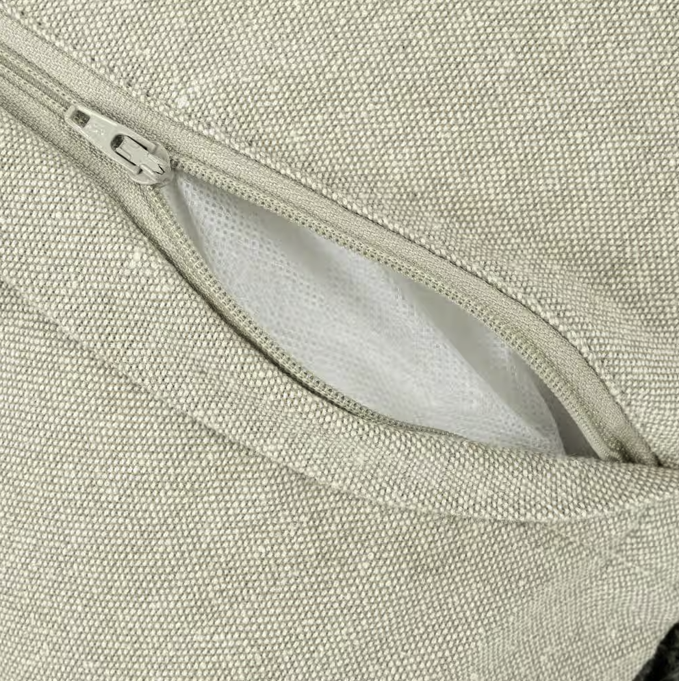 Close-up of a zipper on a textured fabric surface