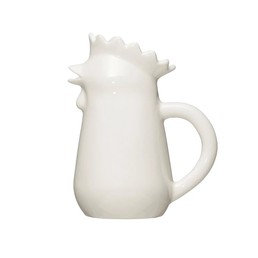 A white stoneware creamer pitcher designed to resemble a chicken.