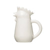 A white stoneware creamer pitcher designed to resemble a chicken.