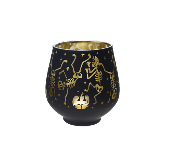 Black candle holder with gold skeleton and pumpkin design on a white background