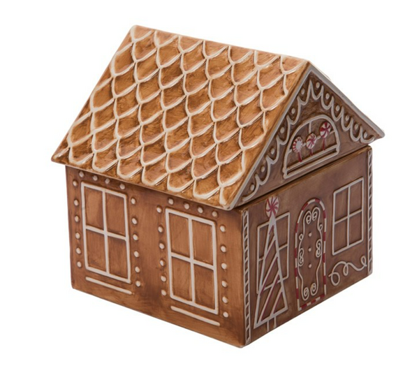 A ceramic cookie jar shaped like a gingerbread house with orange brown color, white lining, and red accents.