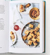 Open book showing a page with a photograph of food on a white surface