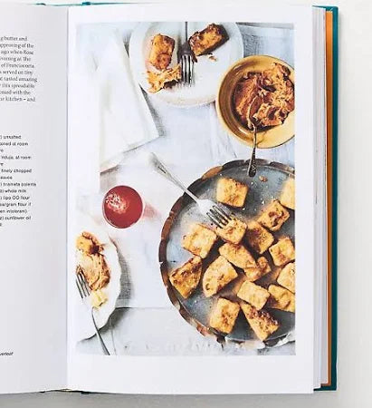 Open book showing a page with a photograph of food on a white surface