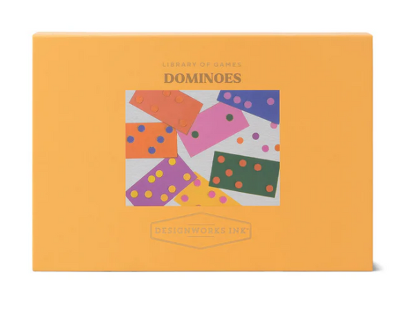 Box of dominoes with colorful tiles on an orange background