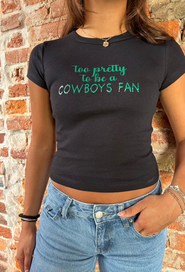 Person wearing a black t-shirt with green text against a brick wall