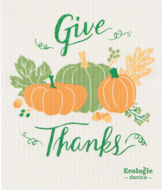 A Swedish dish towel with a give thanks message, featuring a drawing of pumpkins, leaves, and the text 'ecologie - danica'.
